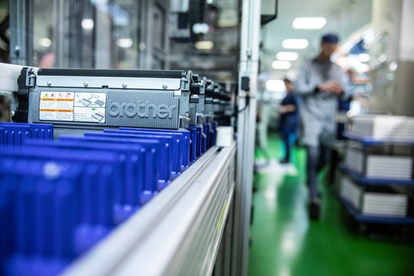 Brother toner cartridge on a production line with a man stood in the background