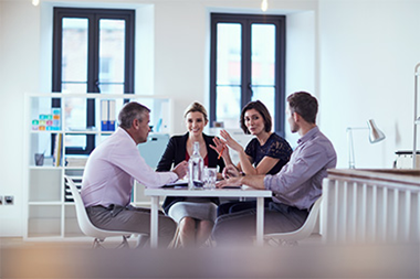 Four business people sitting around a table